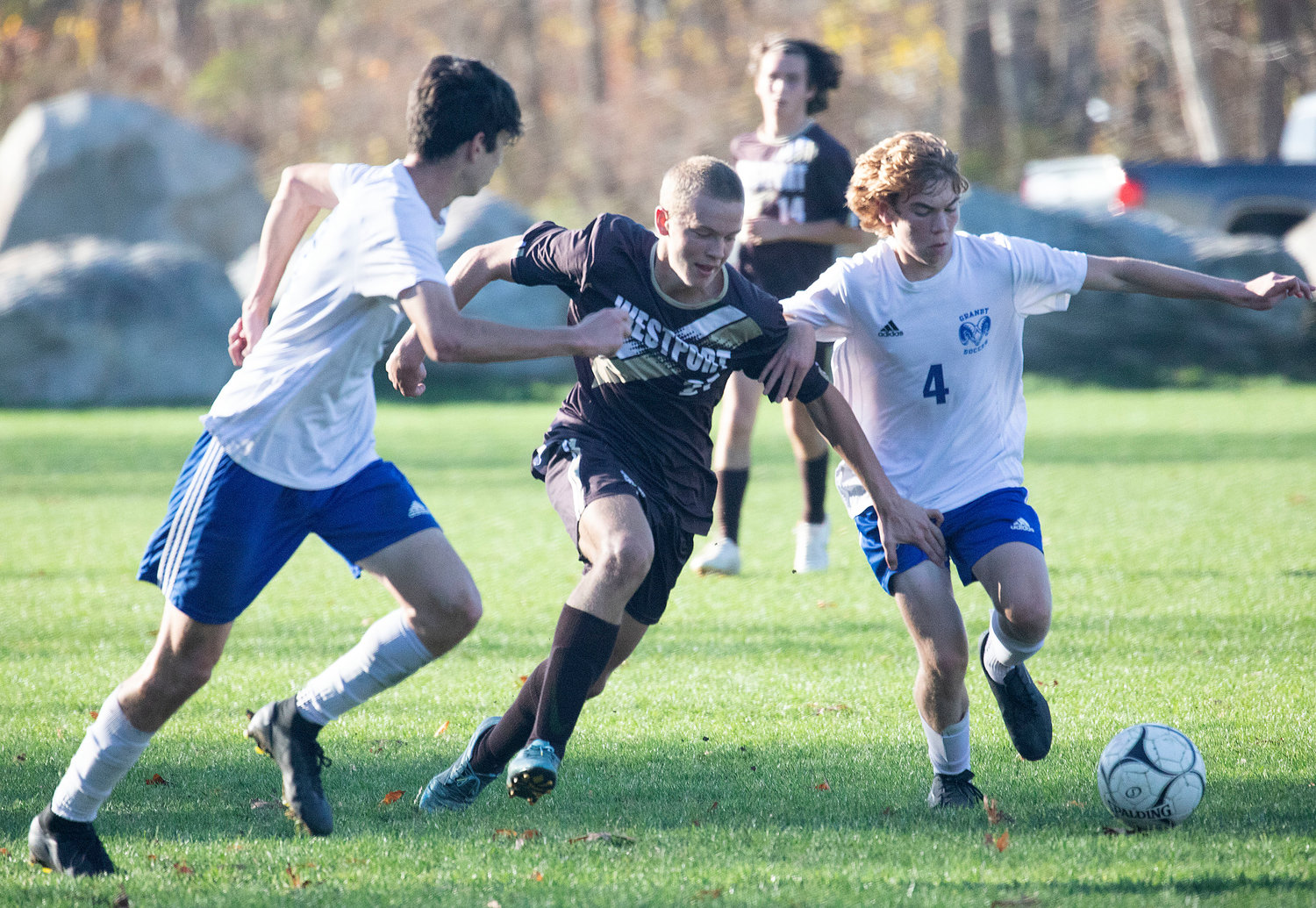 Central midfielder Coltrane McGonigle dribbles the ball upfield before making a pass in the first half. The fearless senior controlled the middle of the field both offensively and defensively.