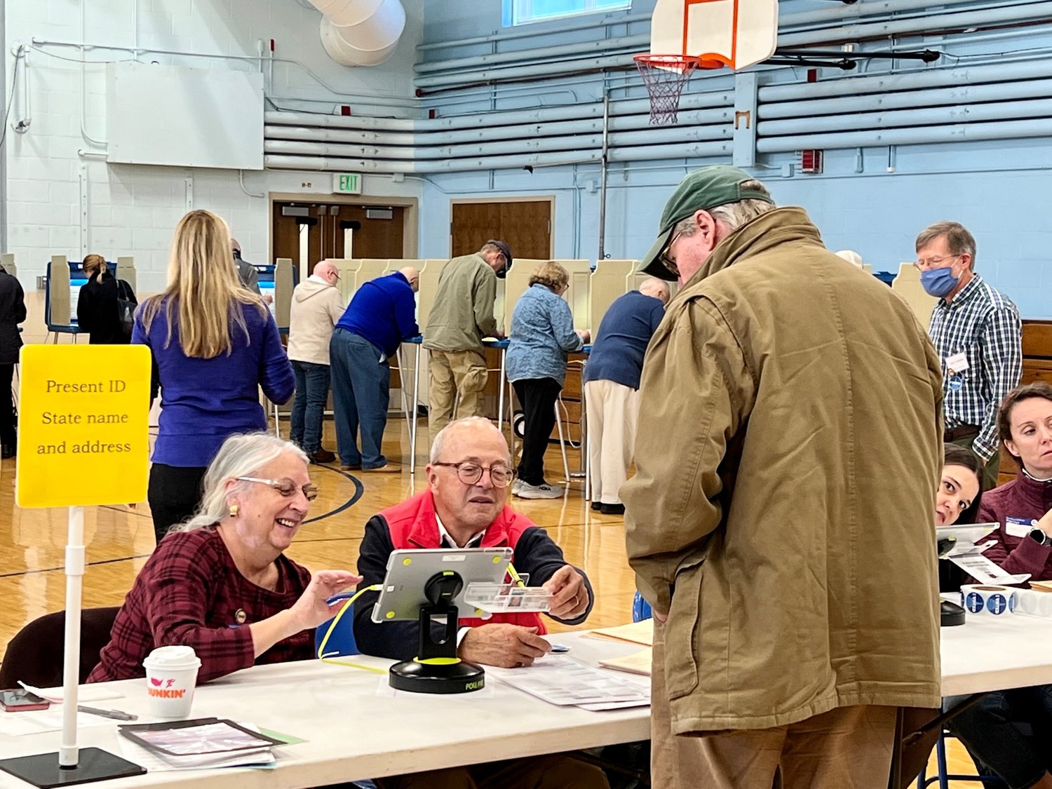 Clerks process voters at the Wilbur McMahon School Tuesday morning.