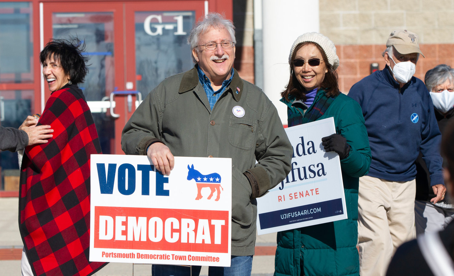 Democratic candidates Len Katzman (for Town Council), and Linda Ujifusa (for R.I. Senate District 11) greet voters outside the Portsmouth High School field house on Tuesday.