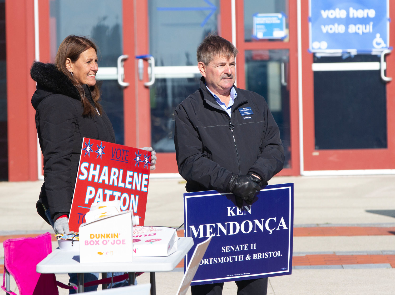 Republican candidates Sharlene Patton (for Town Council) and Ken Mendonça (for R.I. Senate District 11) canvass in front of the Portsmouth High School field house on Tuesday.