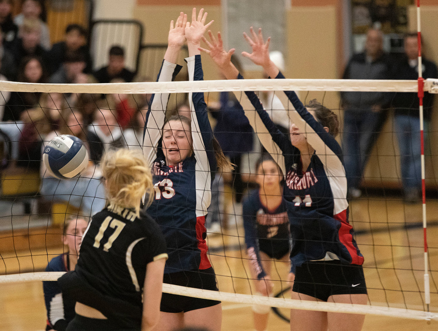 Adelynne Crisfield (left) and Hailey Labonte block a North Kingstown spike.