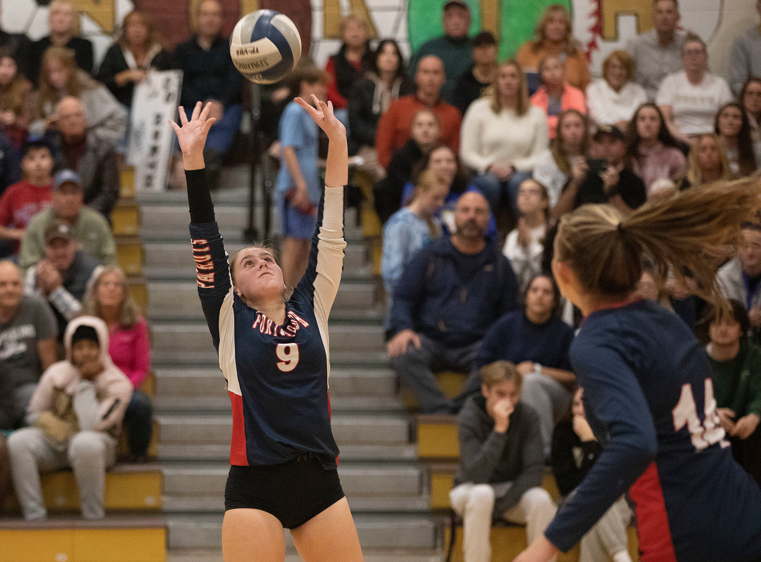 The Patriots’ Caitlin Mediate sets the ball for a teammate.