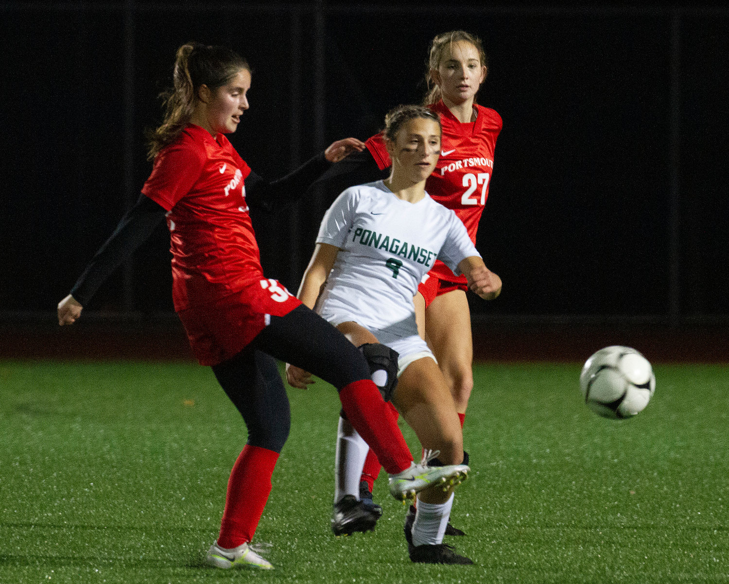 Evelyn Shuster (left) vies for a throw-in as teammate Alexandra Kaull looks on.