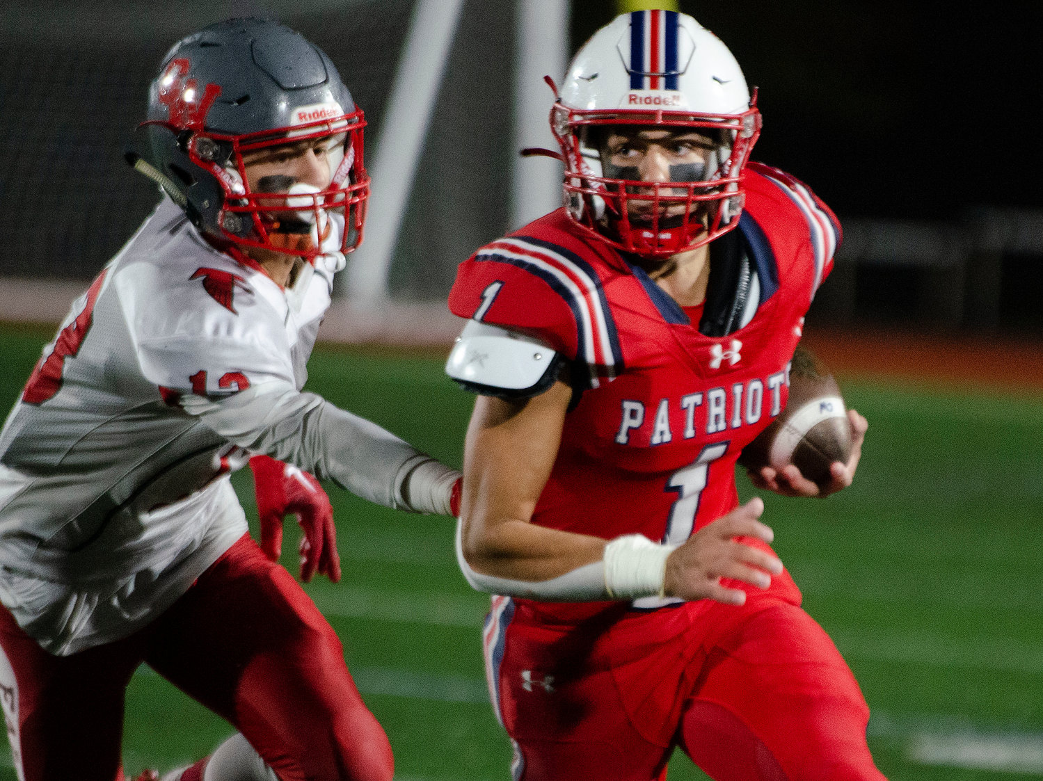 Patriots’ running back Carson Conheeny runs on a sweep in the second half.