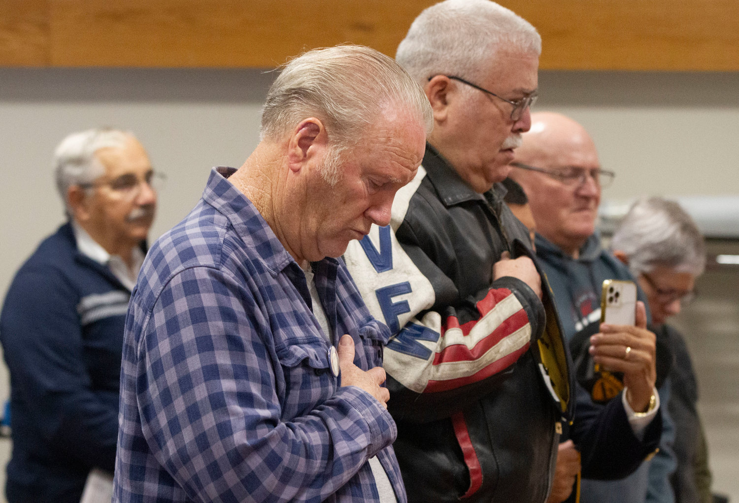 Retired Army veteran Donald Pfeiffer bows his head during the invocation.