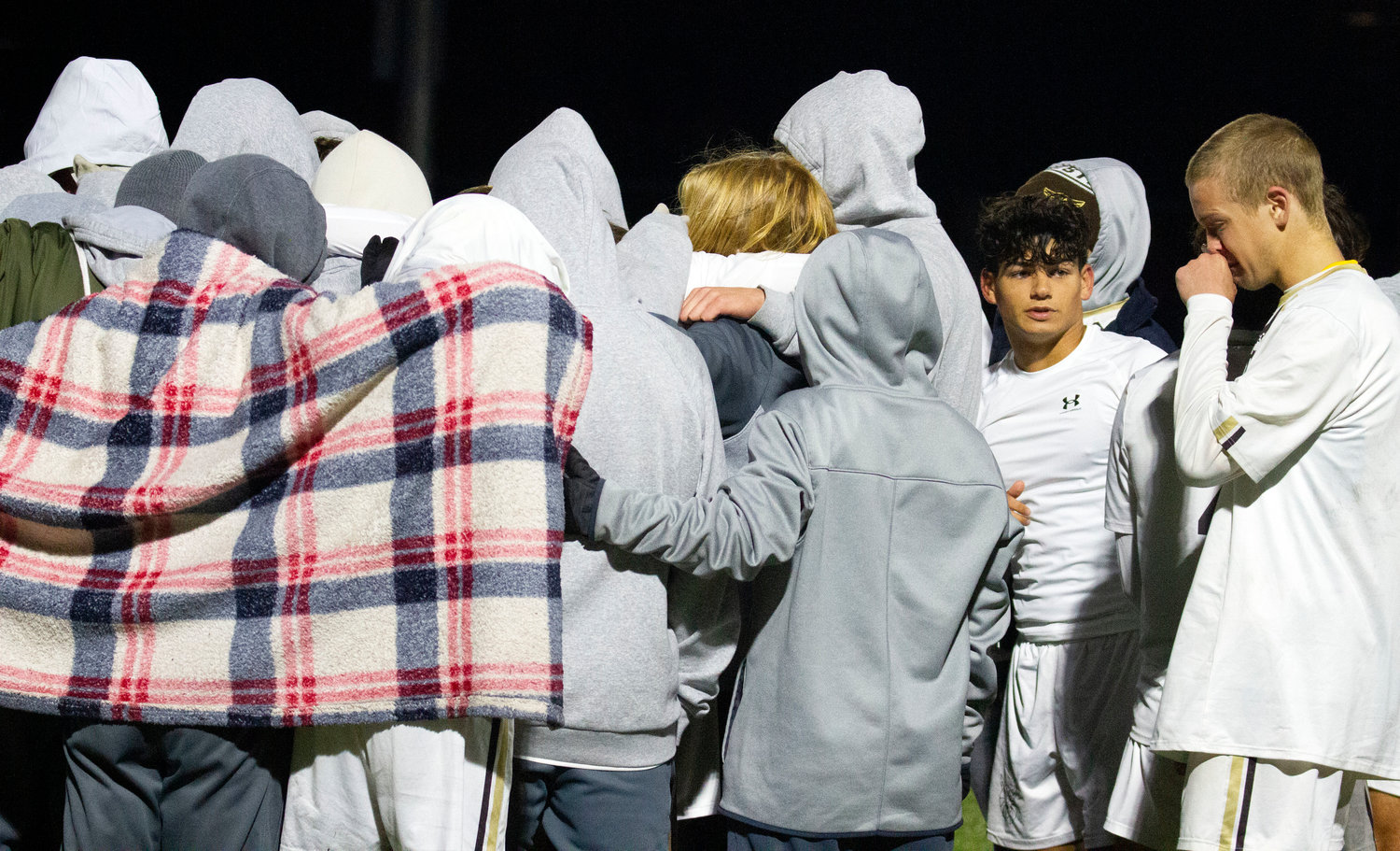 The weepy Wildcats and seniors Antonio Dutra Africano (mid-right) and Coltrane McGonigle (right) huddle after the loss  to state their Wildcat creed for the last time this season.