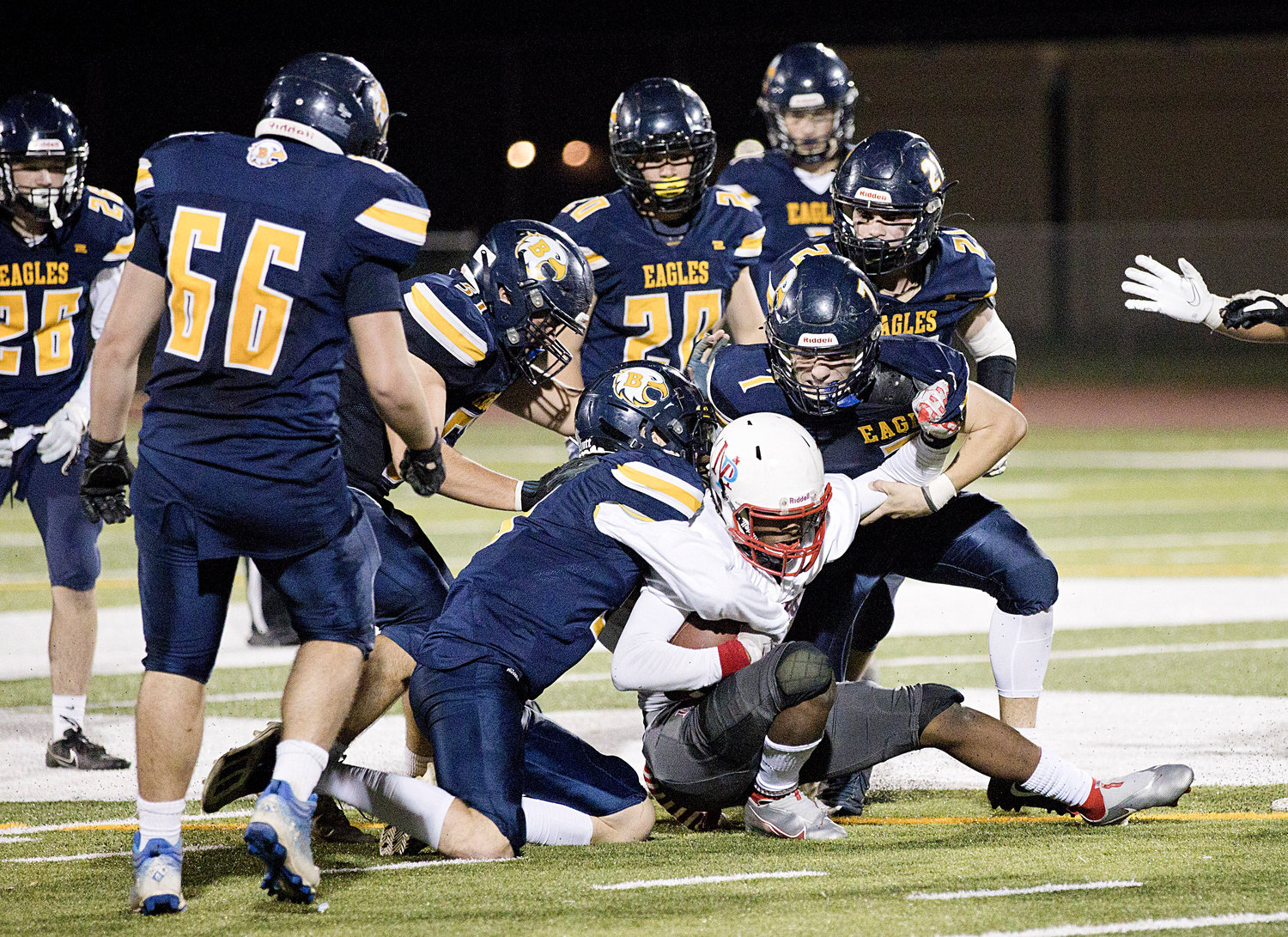 A group of Barrington players tackle a Mt. Pleasant ball carrier.