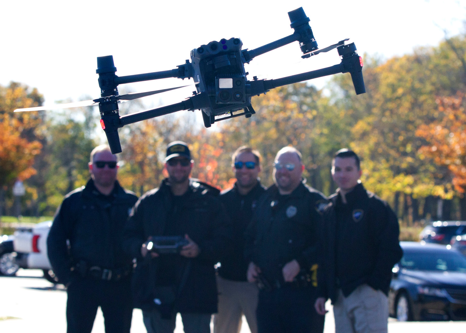 Bristol police officers from left, Mike Kelly, Det. John Nappi, Sgt. Tim Gallison and Tyler Carreiro learn to fly a drone that will be used for police work during the parade and other events.