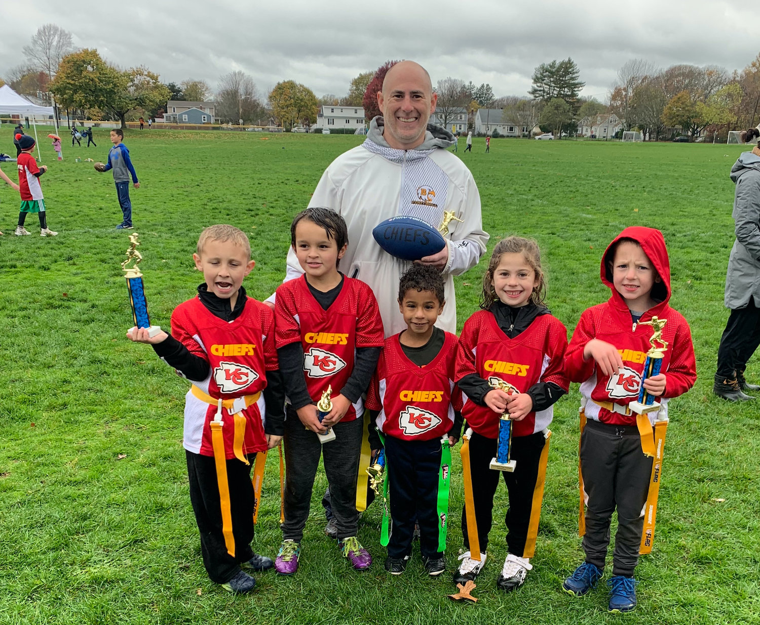 Coach Drew Genetti stands with his 6U Chiefs, after they defeated the Broncos in the division finals.