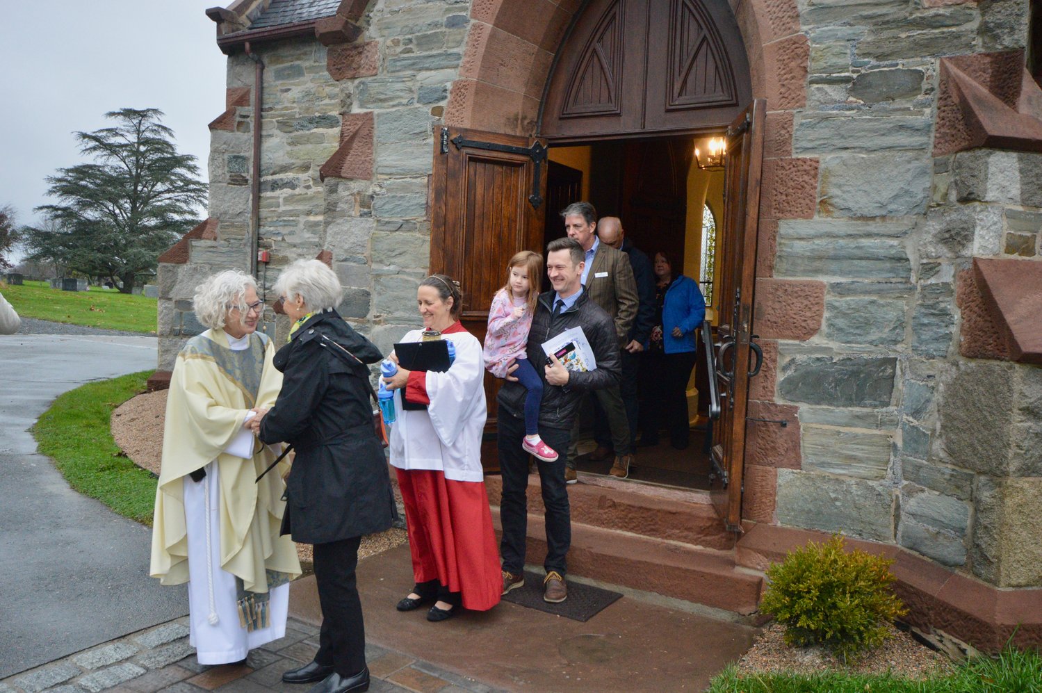 The Rev. Jennifer Pedrick greets parishioners outside the church immediately following the service.