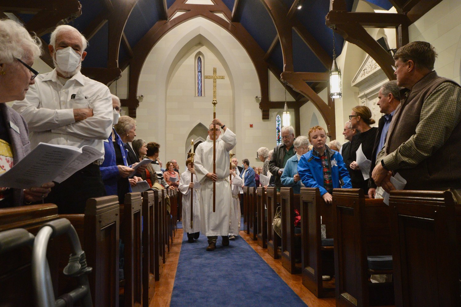 Paul Westrom, who led the first two phases of the renovation project at St. Mary’s Episcopal Church, leads a group of children to the front of the church at the start of the Nov. 13 service, which celebrated the historic chapel’s restoration.