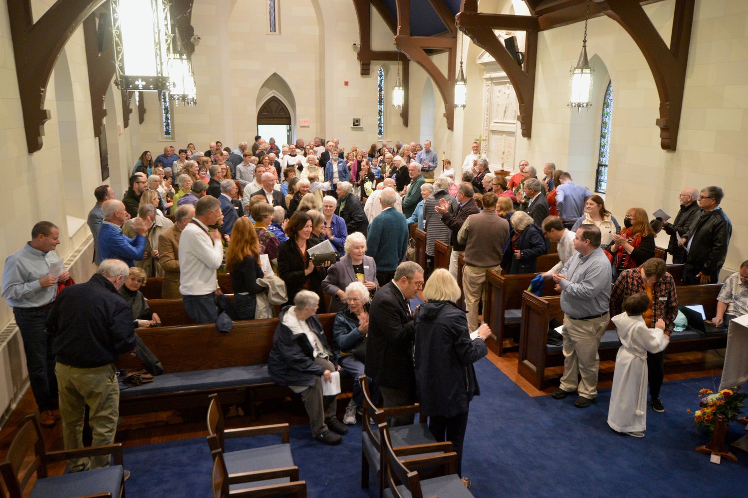 Parishioners who came out to the Nov. 13 service gather their things before learning the church.