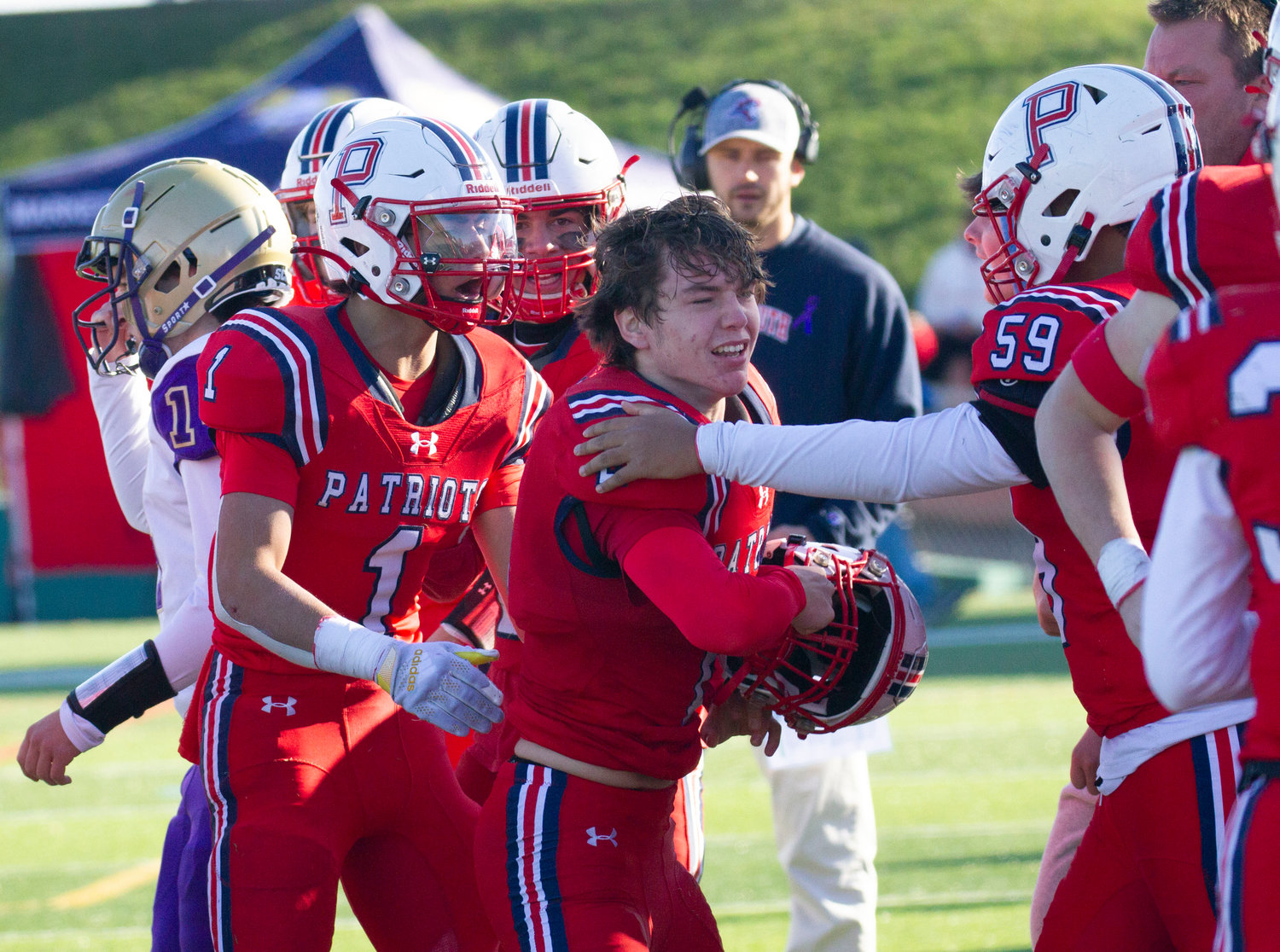 Carson Conheeny (No. 1), Trey Delemos (No. 59) and others congratulate Tyler Hurd (middle) after he made an impressive fourth quarter pass interception.