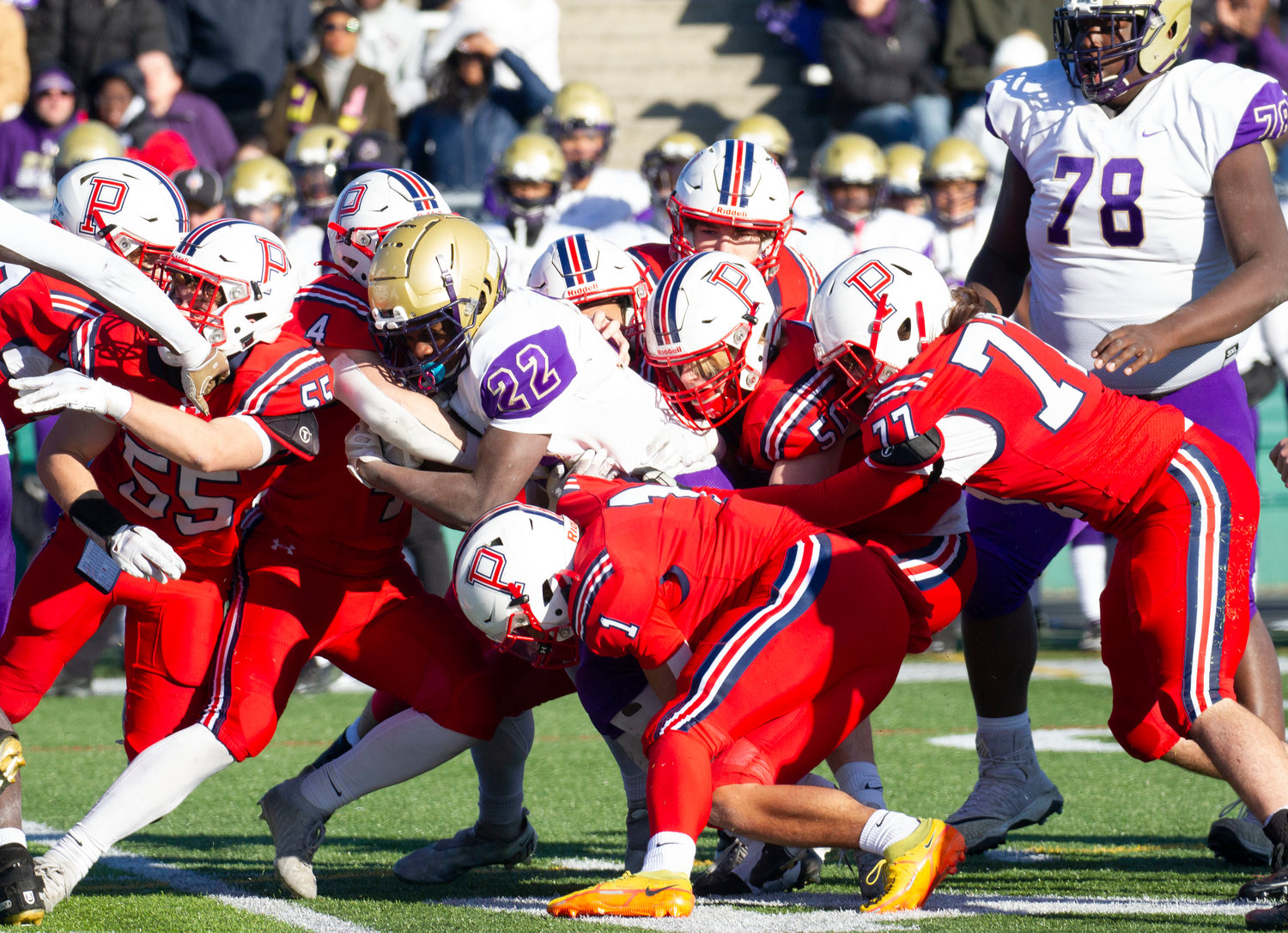 Neal Tullson, Carson Conheeny, Ben Blythe (from left) and others gang tackle Aaron Julius in the fourth quarter.
