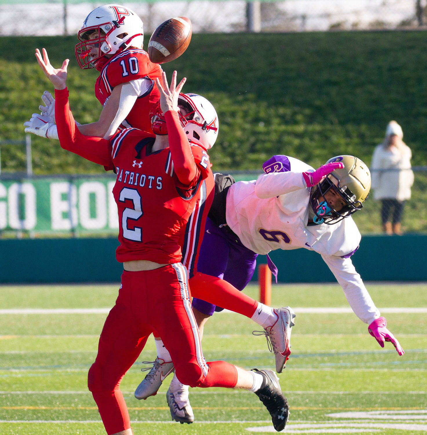 Portsmouth Patriots cornerback Tyler Hurd tips a pass from St. Raphael Academy quarterback Daniel Wulf that was intended for Damien Ocampo (right), in the fourth quarter of Saturday’s Division II Super Bowl at Cranston Stadium.