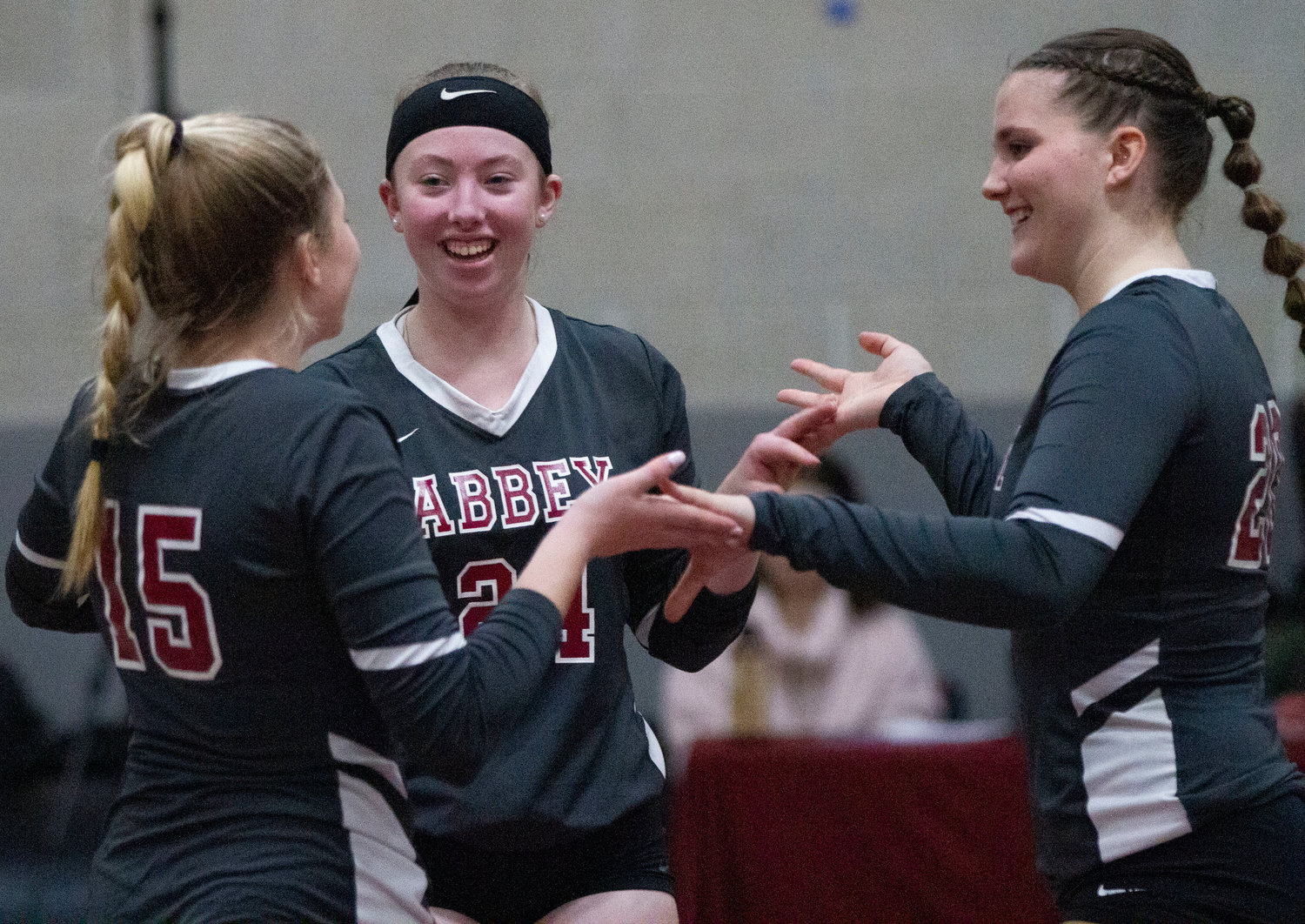 Dakota Ormiston, Bailey Howell and Grace Connaughton (from left) celebrate after a point.