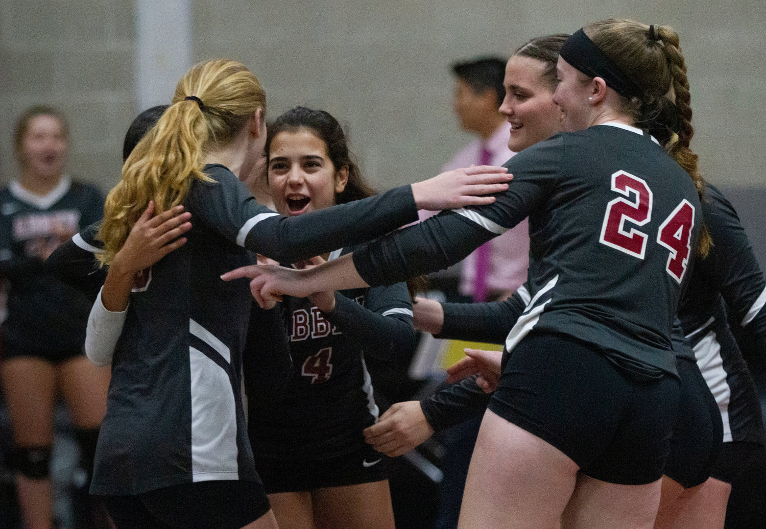 Maria Amian Parames (middle) celebrates with teammates after a point.