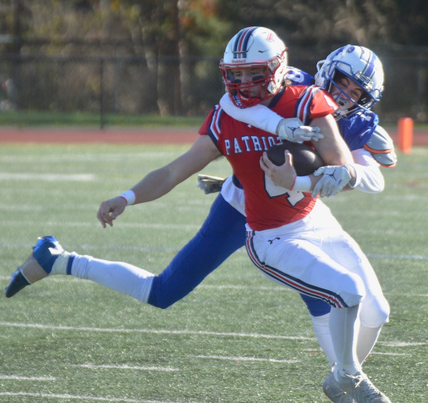 Patriots’ quarterback Neal Tullson is tackled on a keeper.