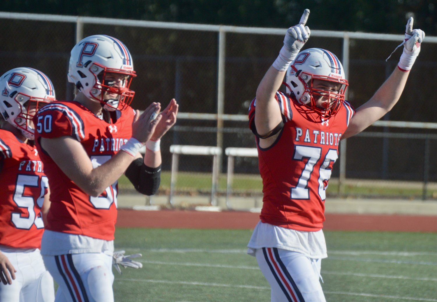 Parker Daigle (right) celebrates the Patriots’ win after the final whistle.
