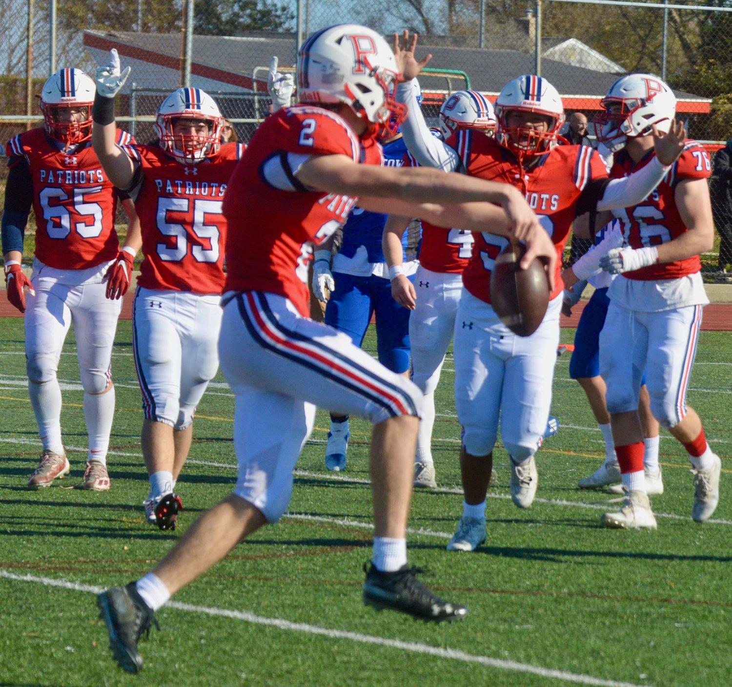 Portsmouth High running back Tyler Hurd and his teammates celebrate his five-yard, fourth-quarter touchdown pass from Neal Tullson against the Islanders in the annual Thanksgiving Day game. The Patriots won, 20-0.
