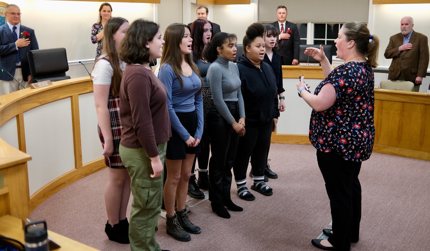 Members of the Portsmouth High School Vocal Ensemble, led by Shawna Gleason, sing The National Anthem at the start of the program.