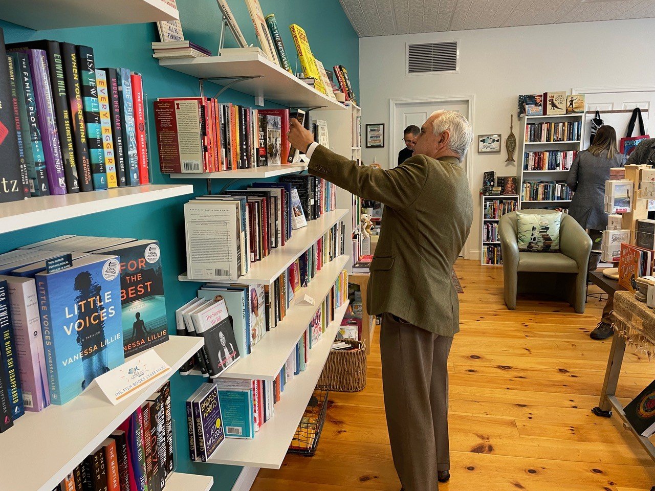 Senator Jack Reed takes stock of the selection at Ink Fish Books on Main Street.