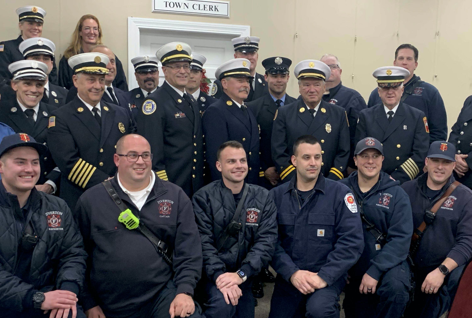 RASMUSSEN

Tiverton Fire Chief William S. Bailey III (middle row, third from left) poses for a photo with his department after his swearing in Monday evening.