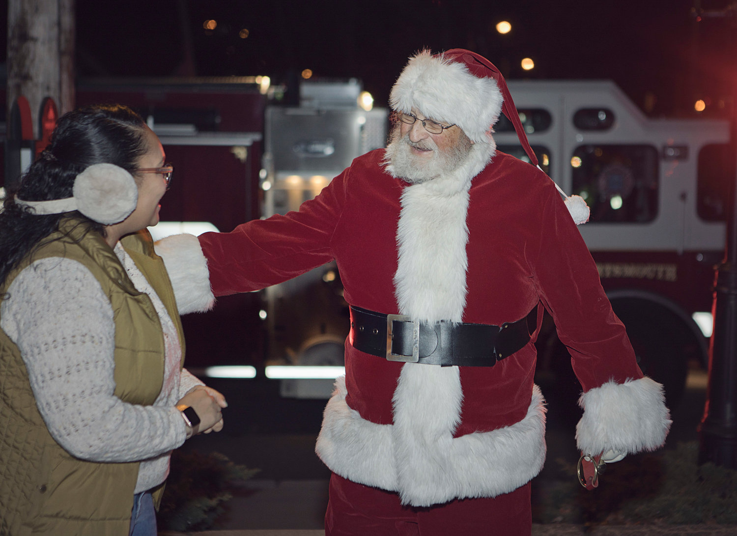 Santa greets an admirer after hopping off the fire truck.
