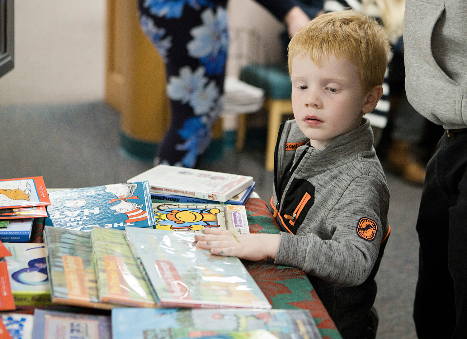 Henry Brown looks over his options while choosing a book to take home.