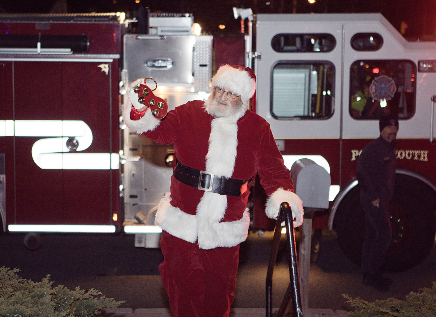 Santa Claus greets families after arriving, by fire truck, to the annual tree-lighting event at the Portsmouth Free Public Library Sunday evening.