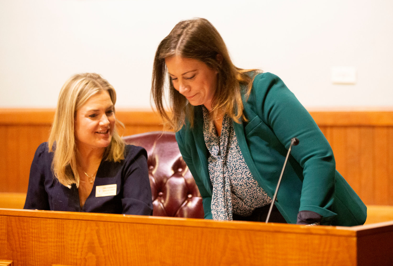 Town council member Annelise Conway (left) speaks with new council member Kate Berard during a swearing-in ceremony on Monday night, Dec. 5.