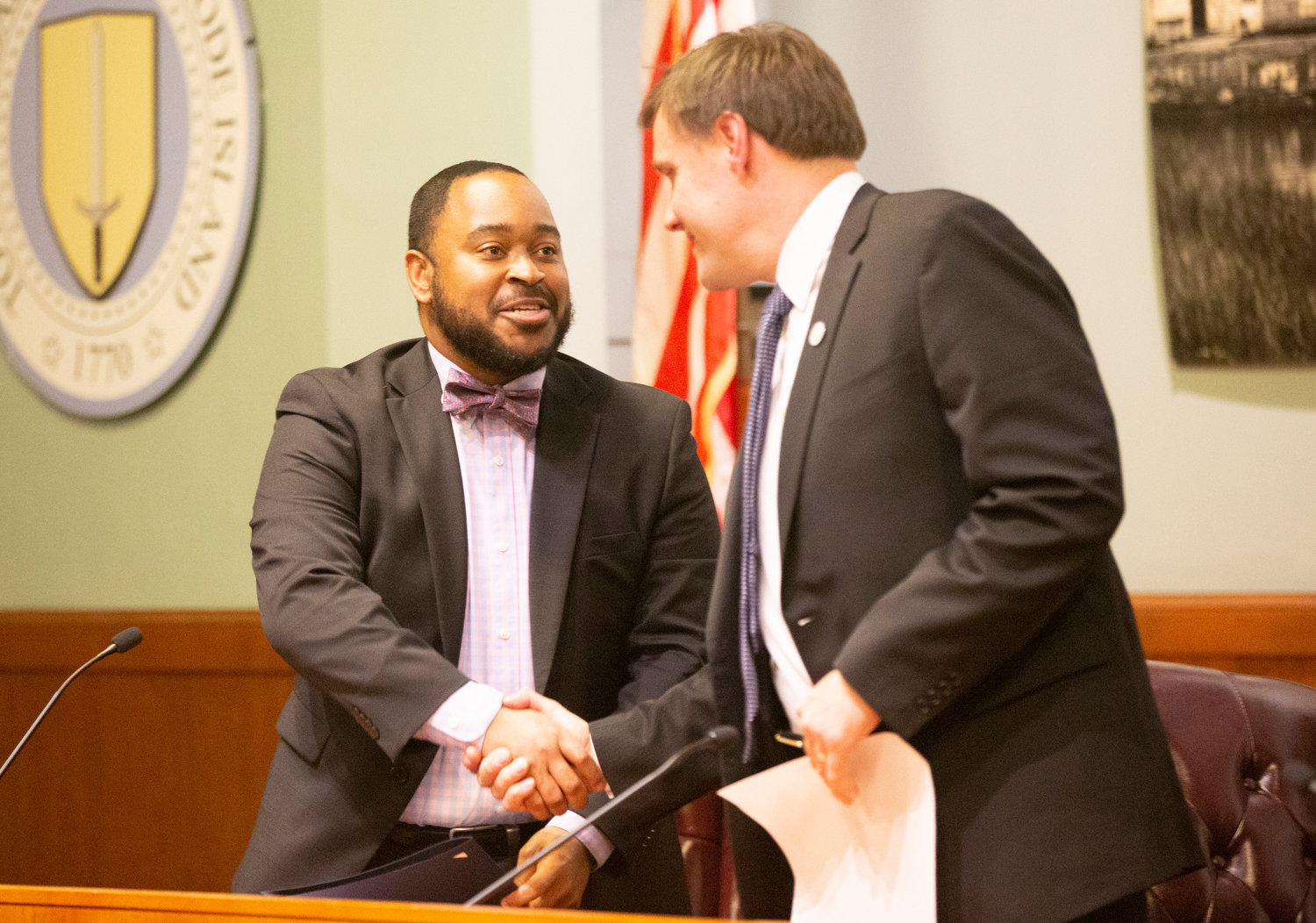 Braxton Howard Medlin (left) shakes hands with fellow councilor Carl Kustell.