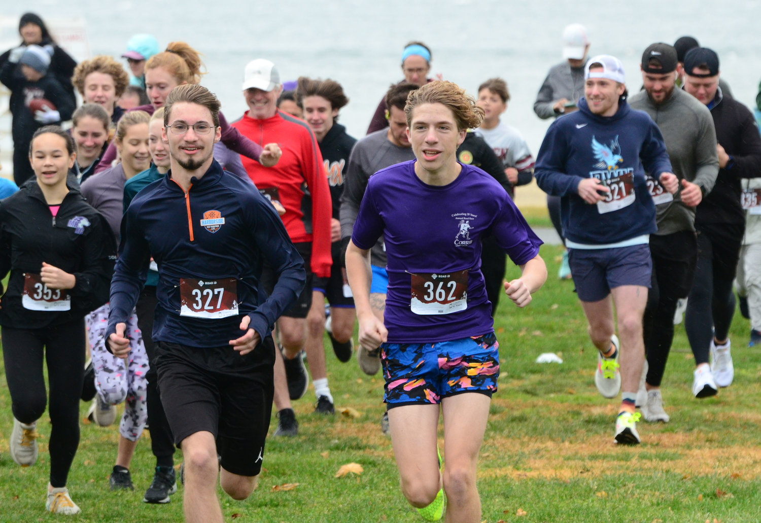 Declan Reed (left, number 327) and Owen Schneck (number 362) lead the group across the field at Bristol Town Beach to start the fundraising race on Saturday.