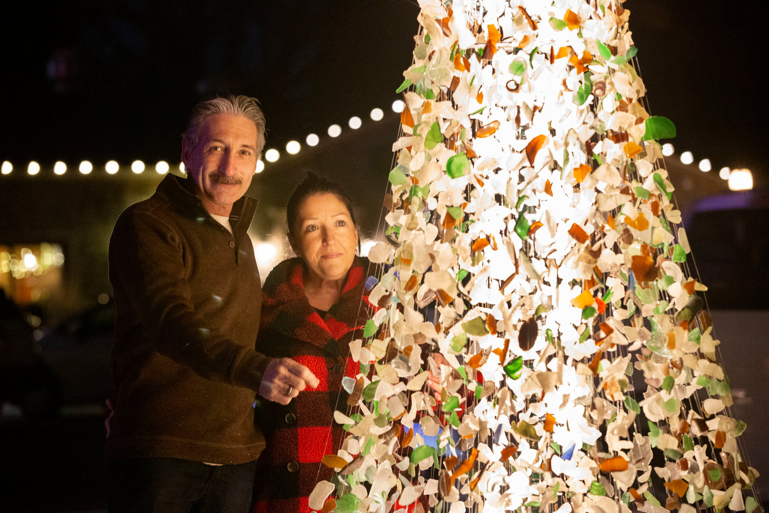 John Viveiros and wife, Snooky display their tree made of locally found sea glass. 