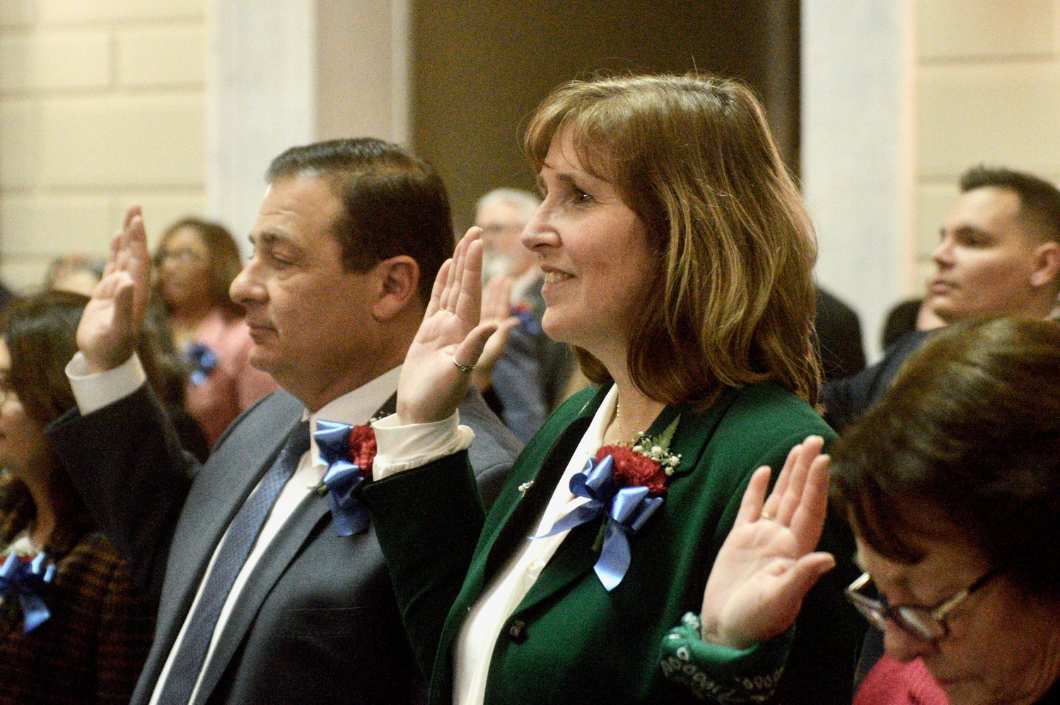 Rep. Michelle McGaw (D-Dist. 71) takes the oath of office to serve her second term in the House of Representatives. At left is Rep. K. Joseph Shekarchi of Warwick, who would be reelected as House speaker just minutes later.
