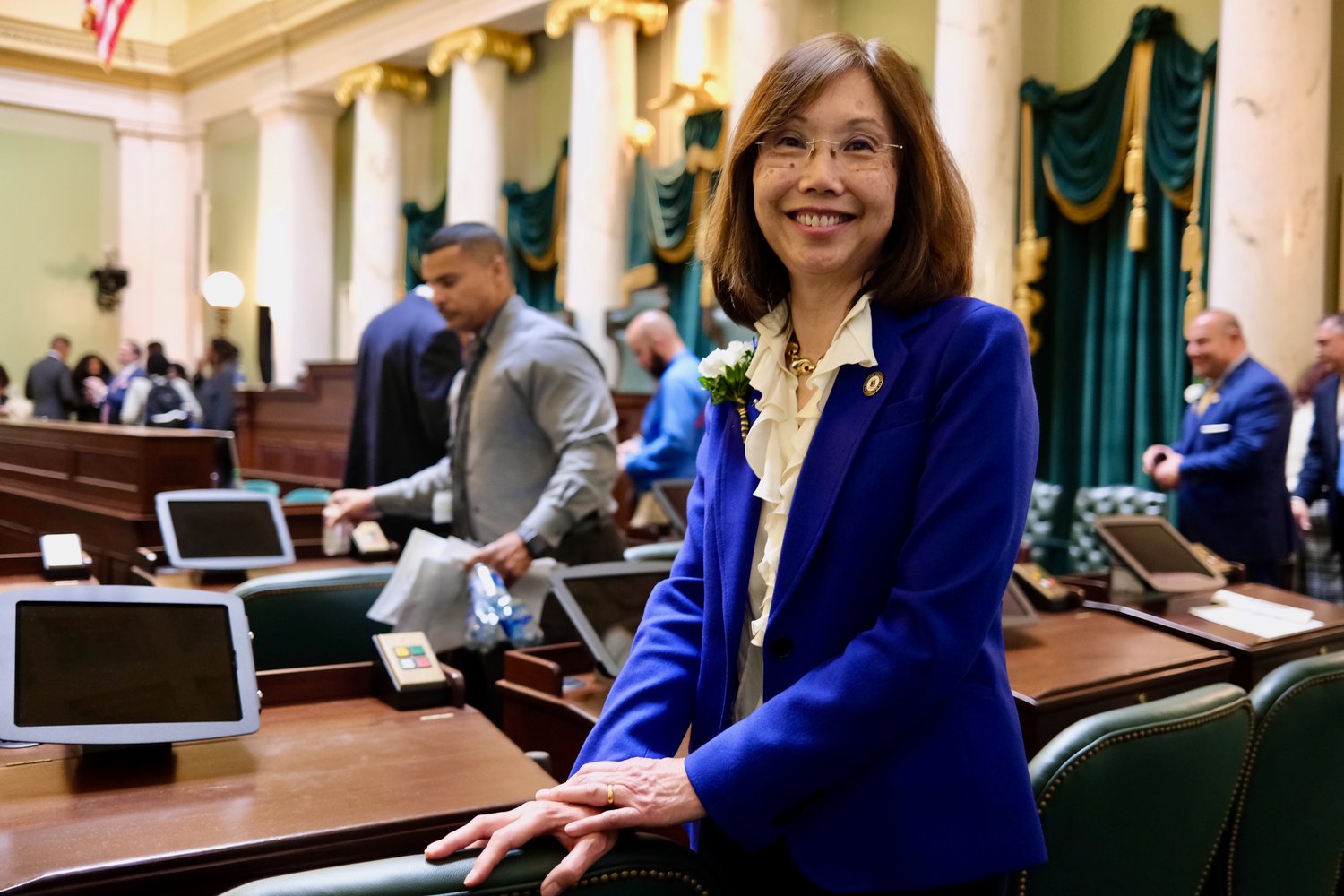 Sen. Linda Ujifusa (D-Dist. 11) at her new desk shortly after being sworn in as a freshman state senator. She and Sen. Victoria Gu of Charlestown became Rhode Island’s first two Asian-American state legislators on Tuesday.