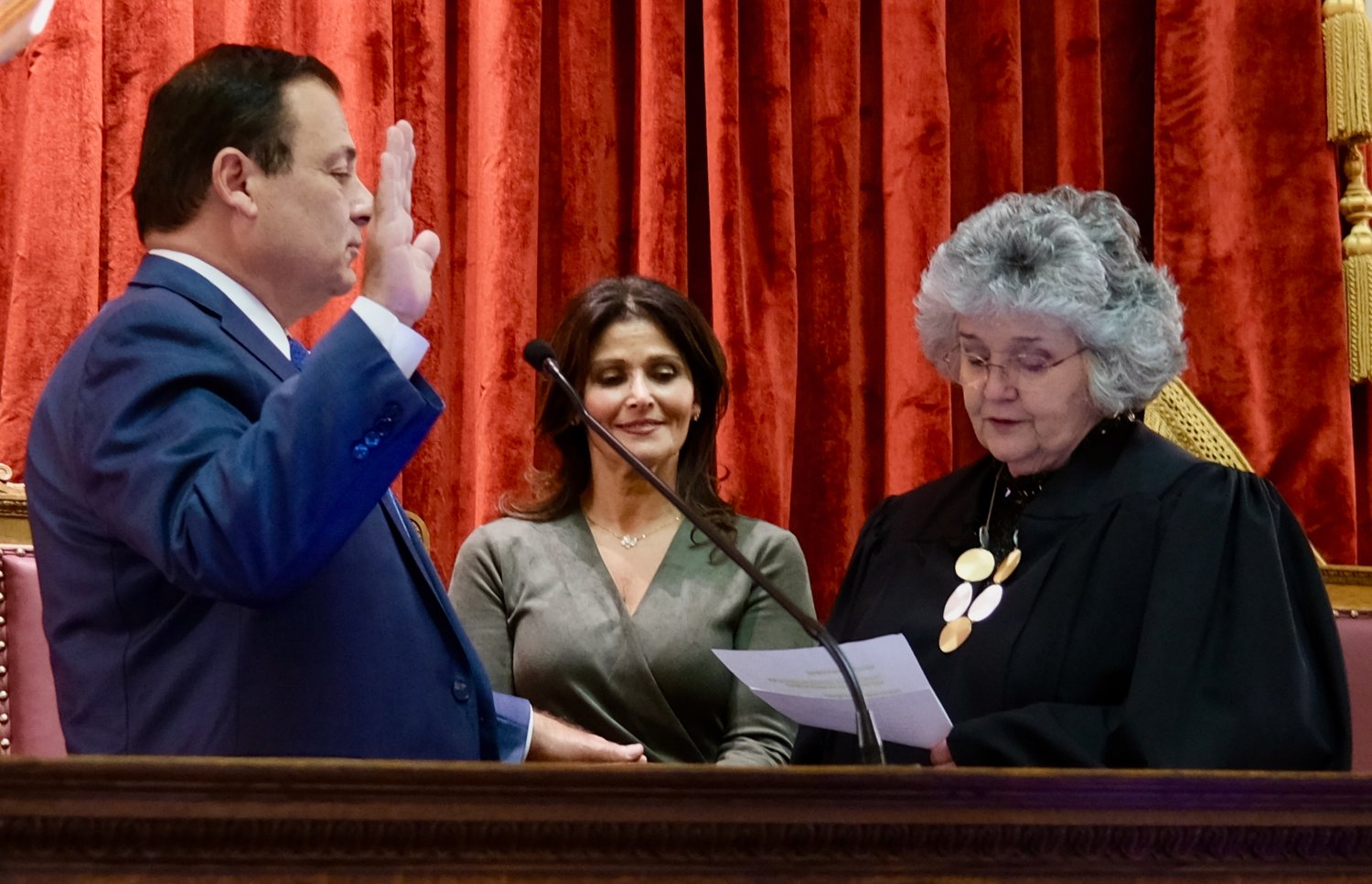 Rep. K. Joseph Shekarchi of Warwick takes the oath of office from Maureen McKenna Goldberg, senior justice of the Rhode Island Supreme Court, after he was reelected House speaker. Looking on is his sister, Mary Shekarchi.