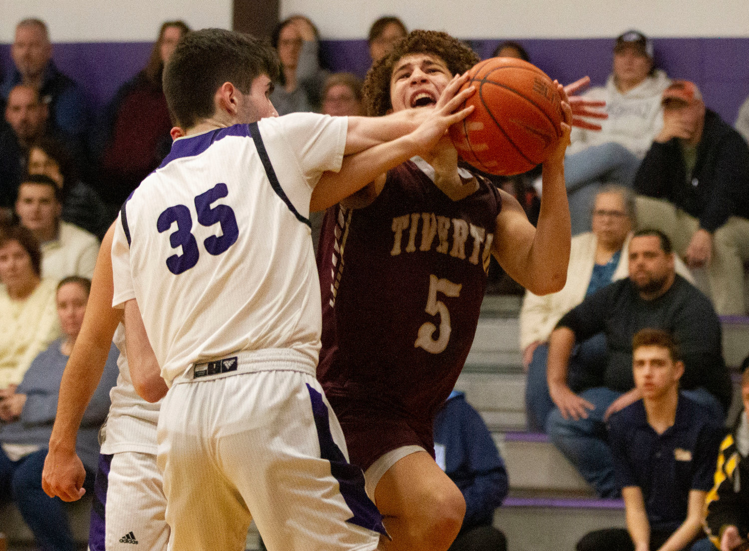 James Rustici fouls Tristin White as he attempts to get to the hoop.