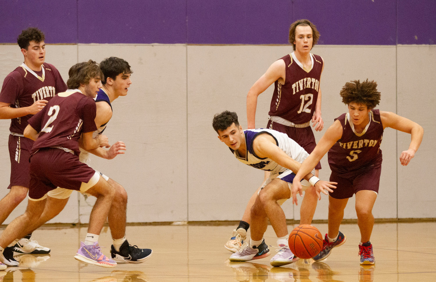 Tiverton’s Tristin White (right) steals the ball off the Huskes’ Parker Camelo in the first half as Tiverton defenders Keegan Dutelle (left), Logan Bouchard and Jason Potvin look on with the Huskies’ Ben Calouro.
