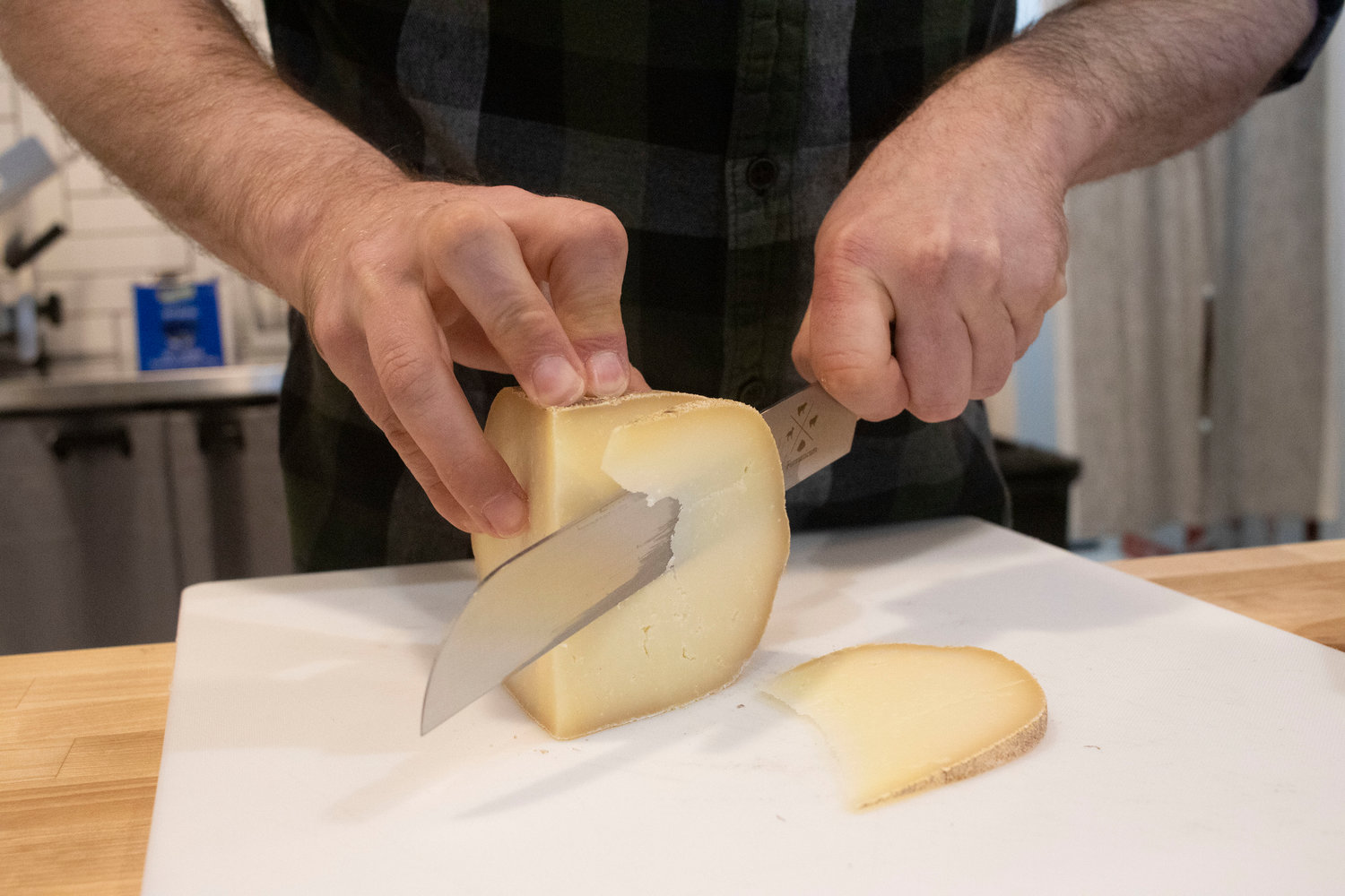 Rind owner Tim Fichera cuts into a block of Verona, a cheese made from sheep’s milk.