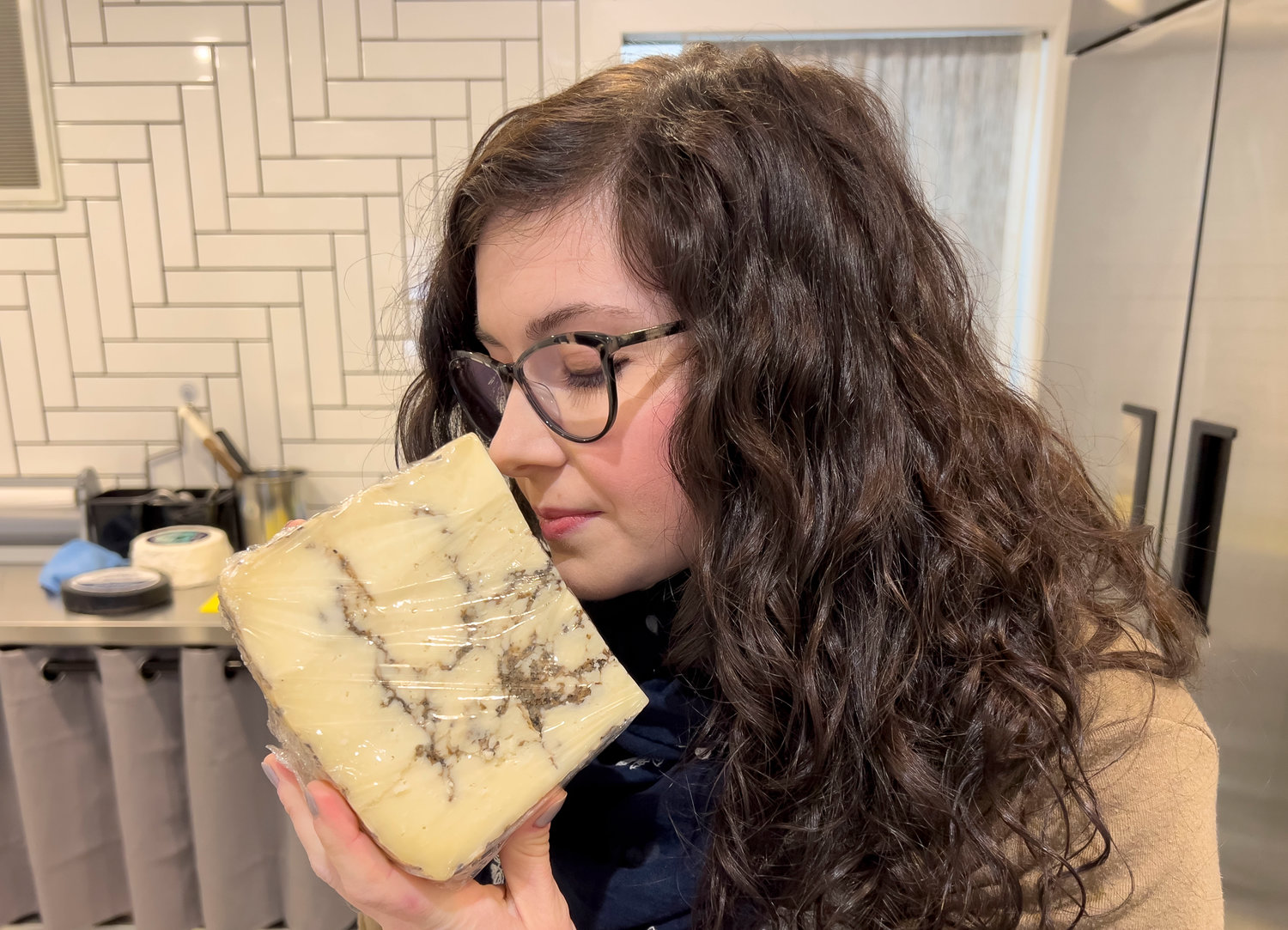 Rind owner Ashley LaPlante holds a block of Moliterno al Tartufo, a cheese that is ribboned with truffles.