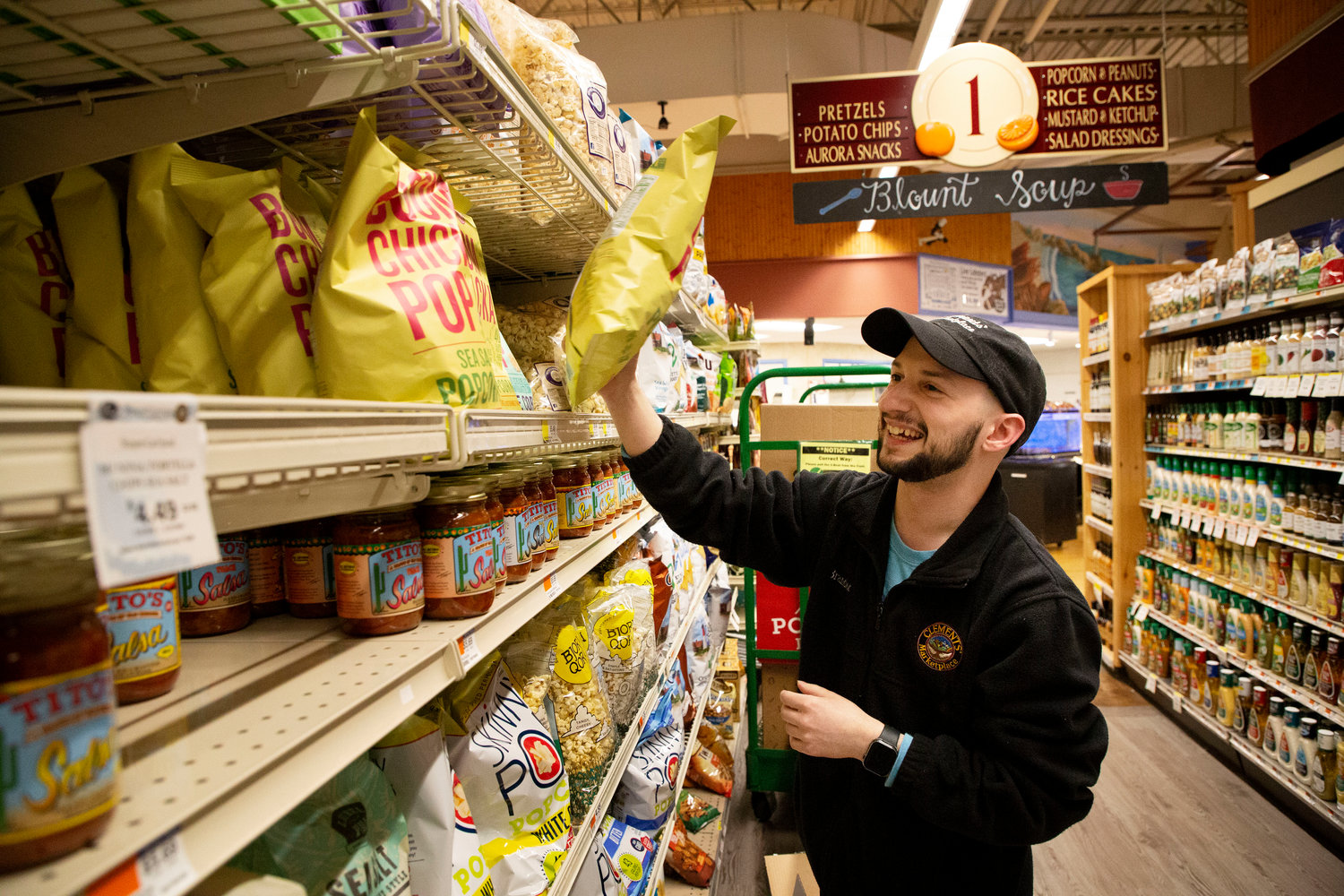 Brandon Raposa stocks chips at Clements’ on Tuesday.