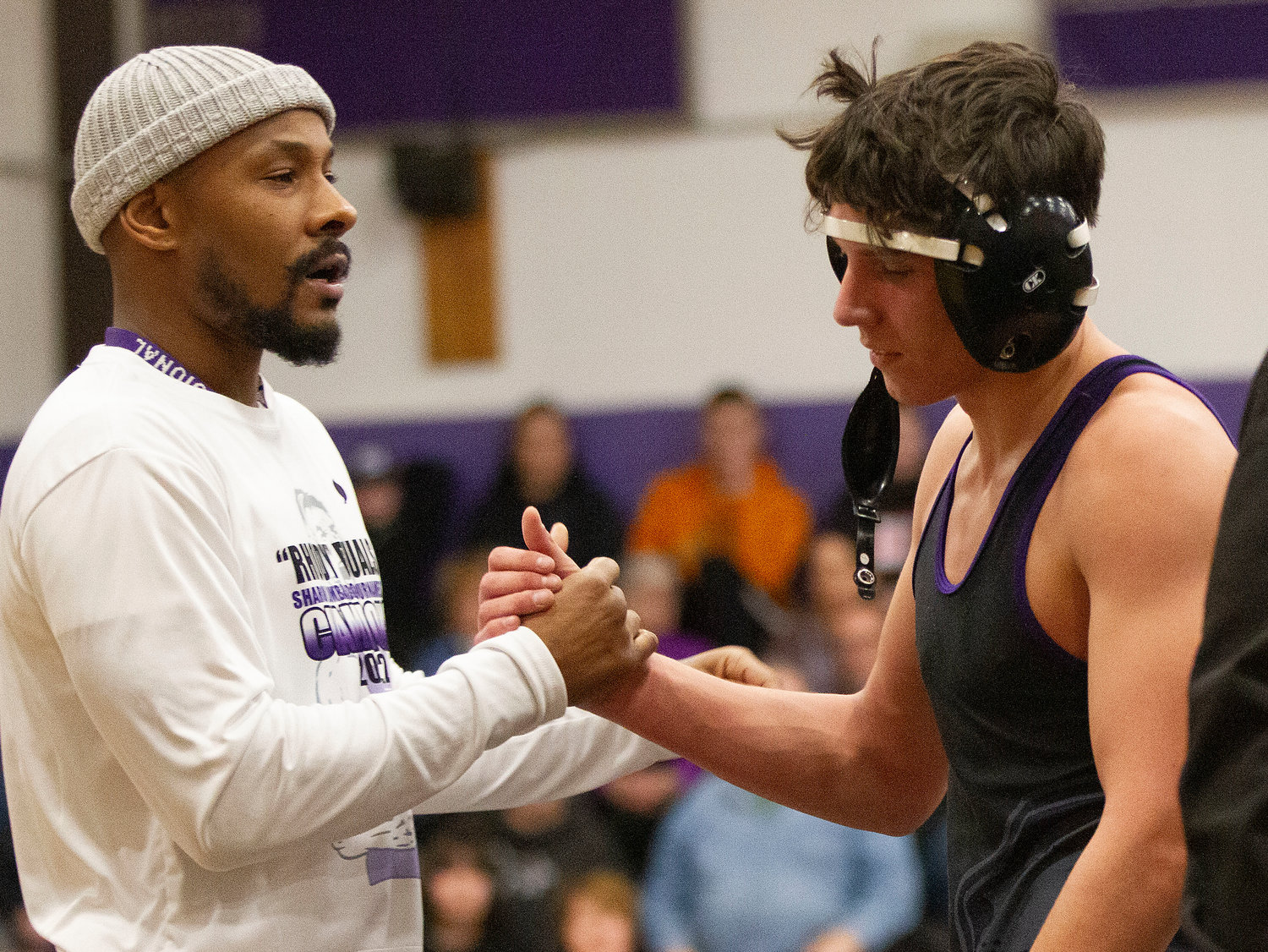 Head Coach Jefferey Eutsay shakes hands with Mason Furtado after he won his match, beating Cumberland’s Jake St. Godard by a decision at 145 pounds. “Mason’s a great wrestler,” Coach Eutsay said. “He’s ready to go every match. I couldn’t ask for a better captain.”