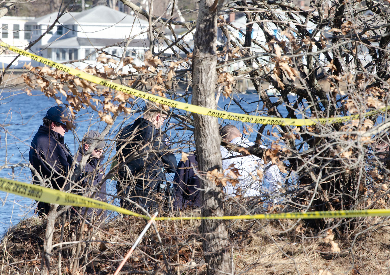 Barrington Police, firemen and medical examiners look over the scene where a body was discovered on Wednesday afternoon.