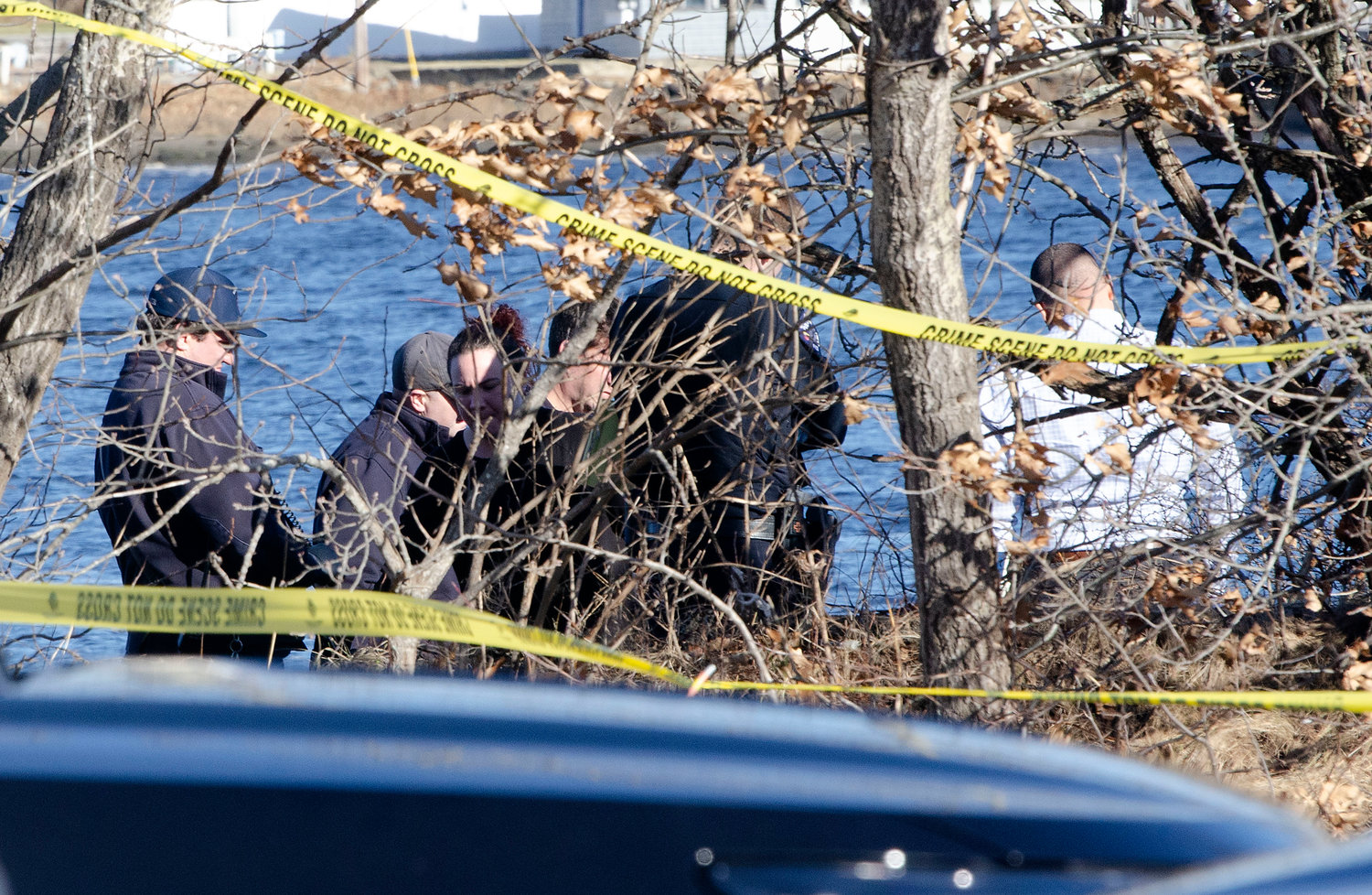 Barrington Police, firemen and medical examiners look over the scene where a body was discovered on Wednesday afternoon.