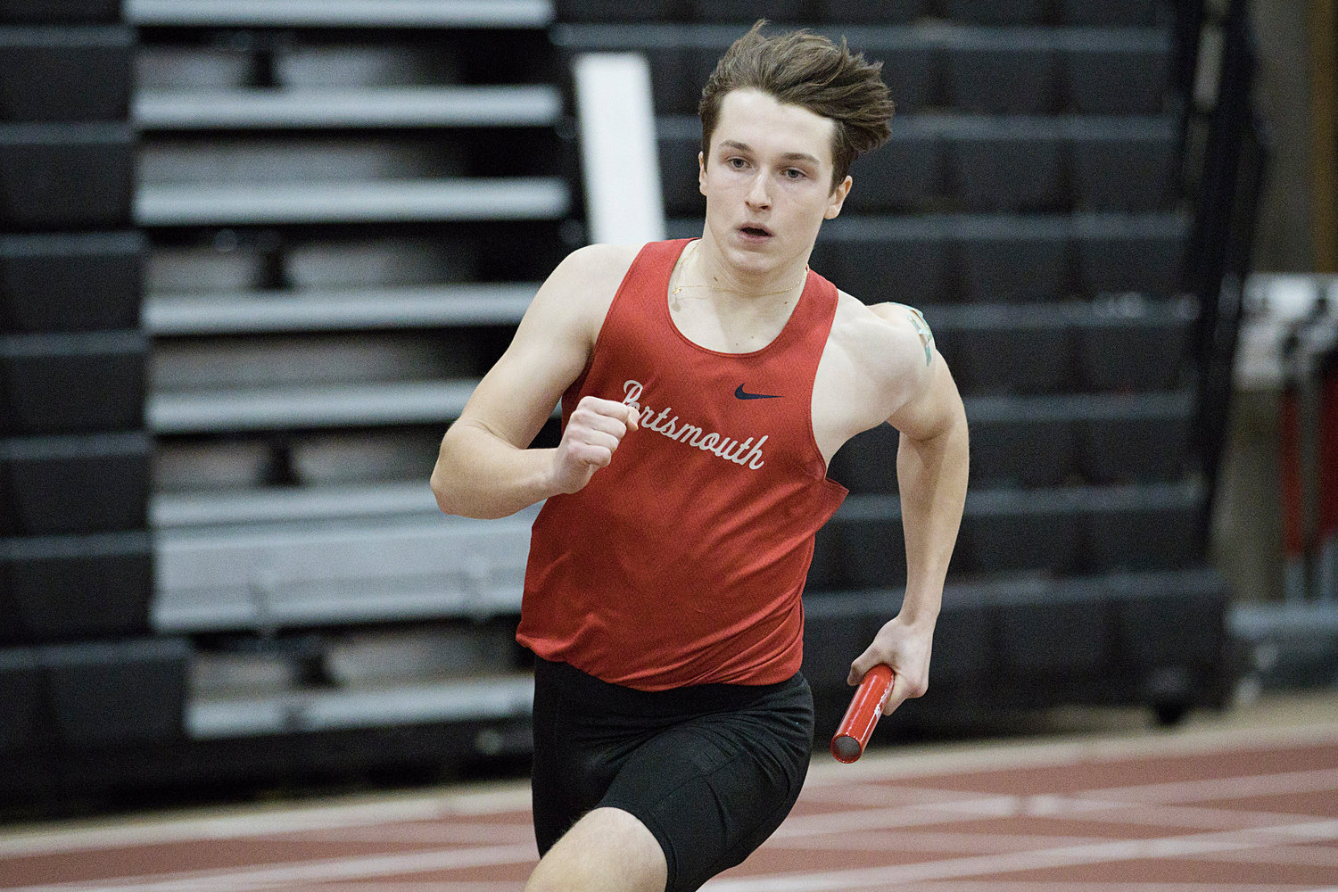 Maciej Tabak races around the track while running a leg of the 4x400-meter relay.