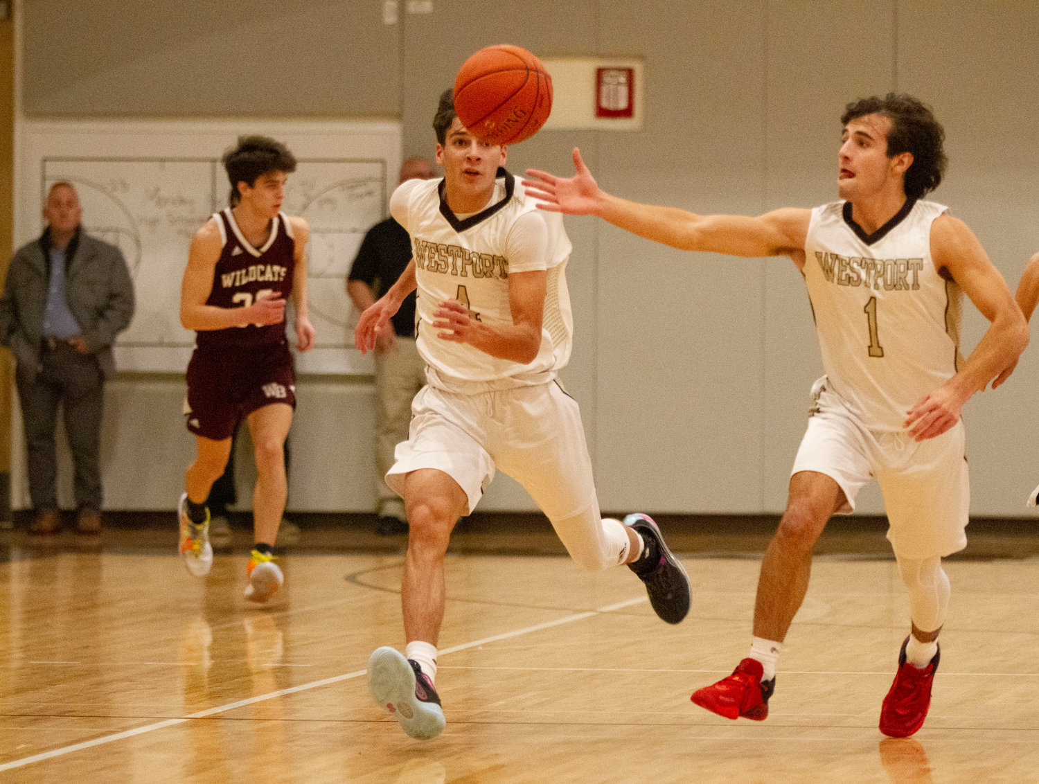Owen Boudria (left) looks on as Hunter Brodeur makes a steal and heads up court on a fast break.