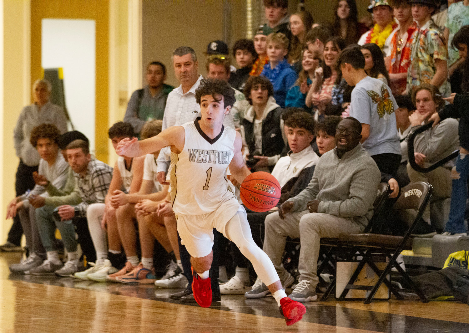 Coach Scot Boudria assistant coach Lloyd Aurora look on as Hunter Brodeur dribbles up court on a fast break.