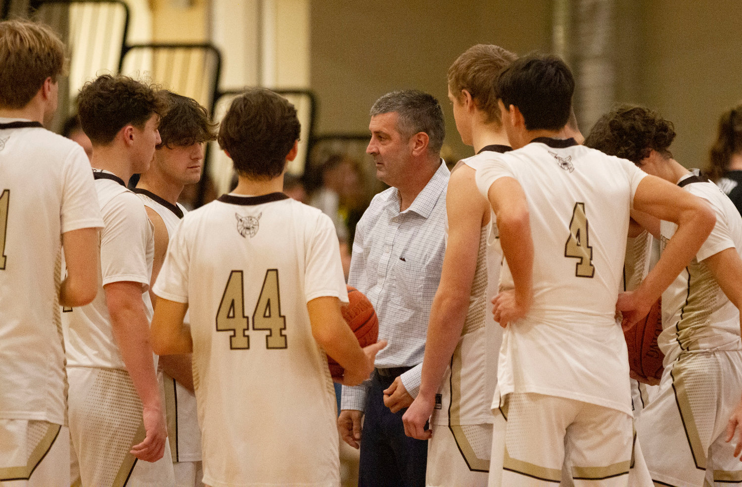 Coach Scot Boudria speaks to the team before the game.