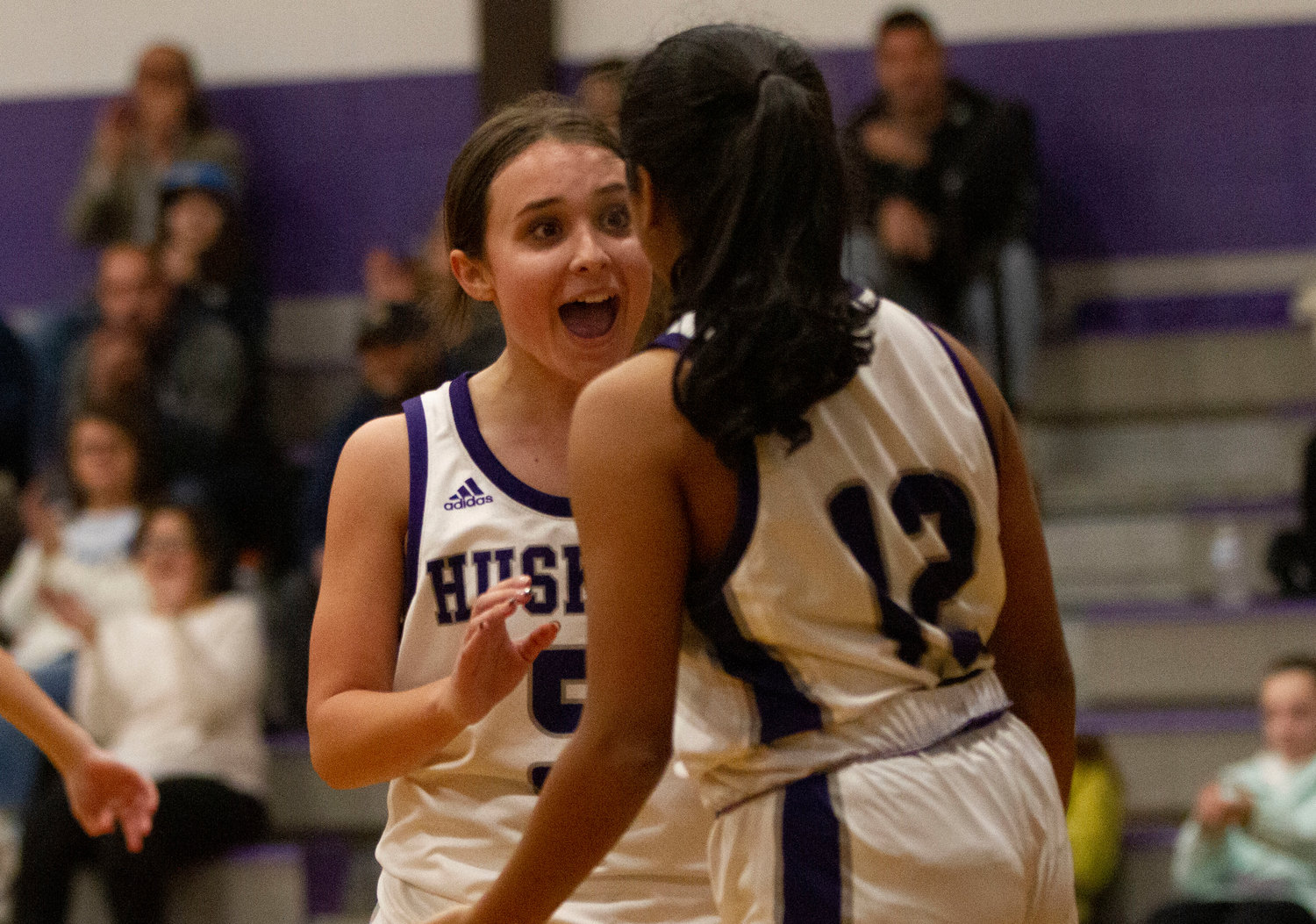 Maddy Butterworth gives kudos to teammate Shivani Metha after she made a basket and collected a foul.